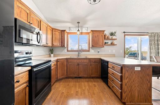 Well appointed Kitchen has updated black-stainless appliances (2018), window above the sink and a pantry.