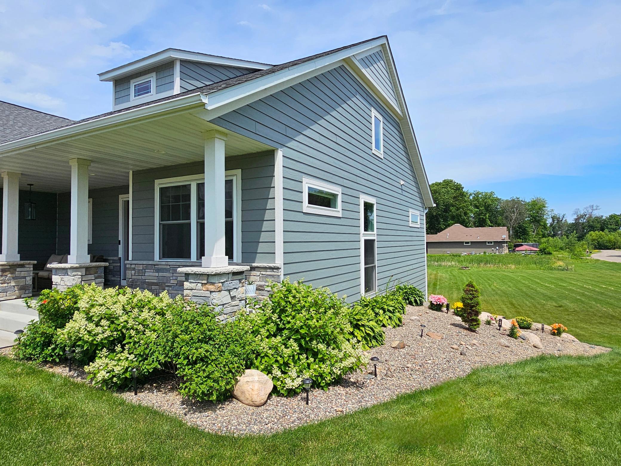 Landscaping features gorgeous blooming bushes, perennials & hostas! (Seller Photo)