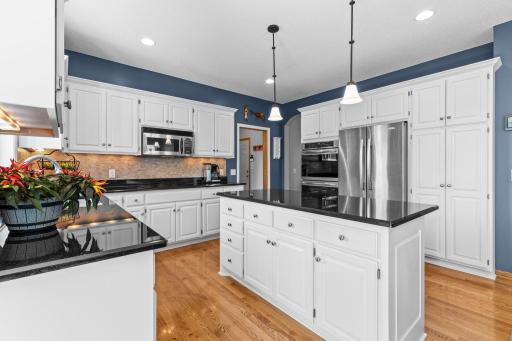 Glass-front display cabinetry adds an elegant custom touch to the kitchen.