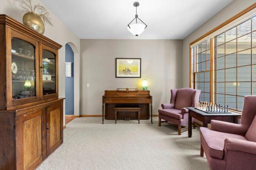 Flexible formal dining or music room features beautiful custom grid windows. Custom grid windows add architectural interest and abundant natural light.