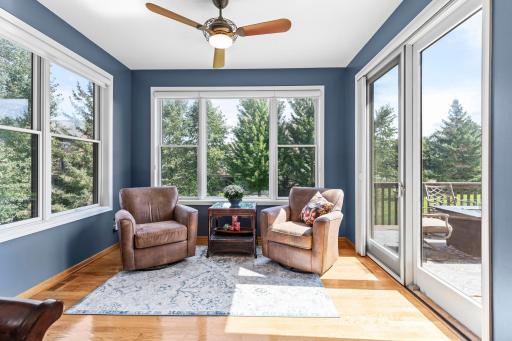 Light-filled sunroom offers a comfortable extension of the main-level living space.
Sliding glass doors provide direct access from the sunroom to the backyard deck.
