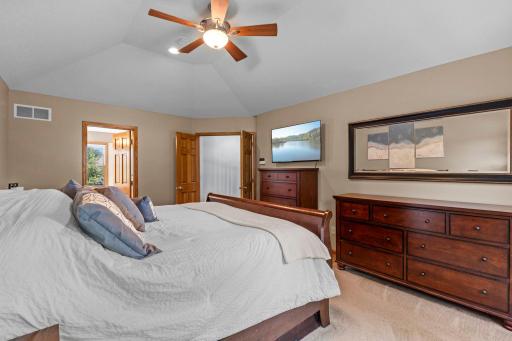 Double six-panel doors create a grand entrance into the private primary suite.