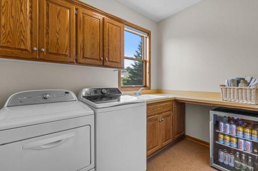 Dedicated main-floor laundry room features a utility sink and new washing machine installed in 2025.