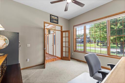 Dedicated main-floor office is tucked behind French doors for privacy. Private home office offers an ideal setting for working from home or quiet study.
