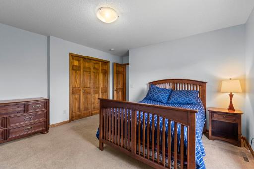 Upper level features four spacious bedrooms, including the private primary suite. Spacious secondary bedroom offers excellent natural light and versatile furniture placement.