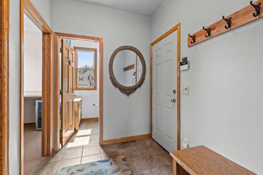 Functional mudroom includes a built-in boot bench and convenient everyday storage. Main-floor powder room is conveniently located near the primary living spaces.