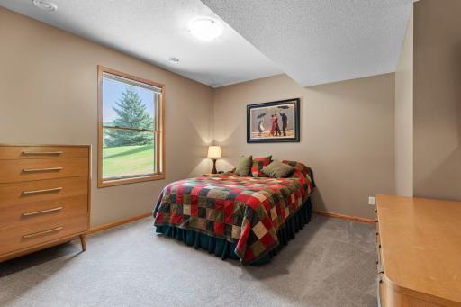 Spacious lower-level guest suite provides a private and comfortable retreat. Private guest bedroom is conveniently located near the lower-level three-quarter bath.
