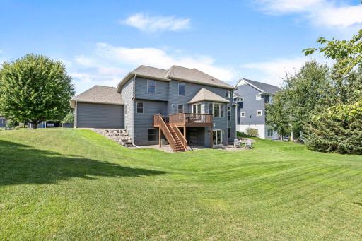 Mature trees provide attractive natural screening and a peaceful backyard setting. Sliding doors from the sunroom make indoor-outdoor entertaining easy.