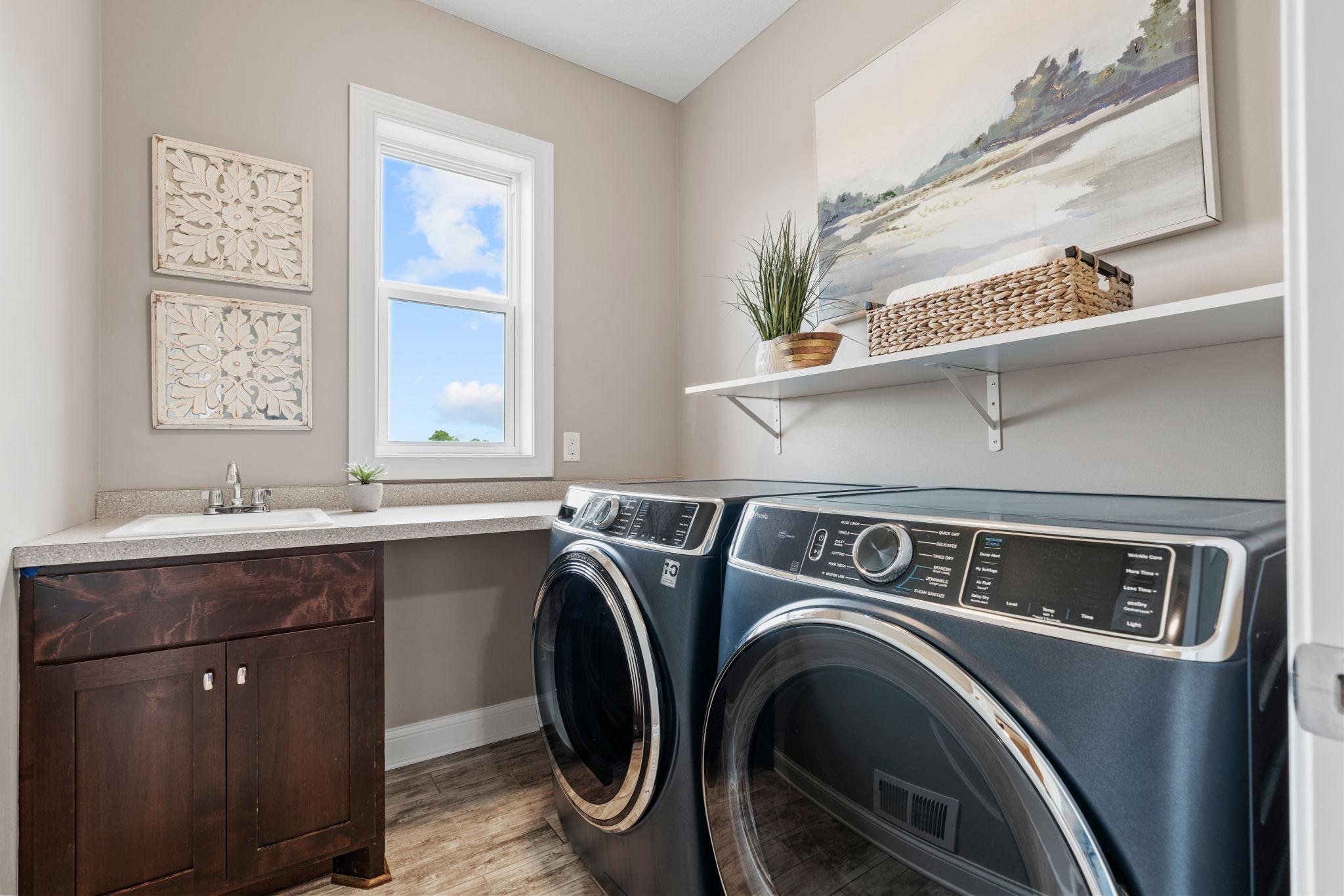 Mudroom w/ custom lockers, desk nook and Laundry Room w/ front-load washer/dryer + sink