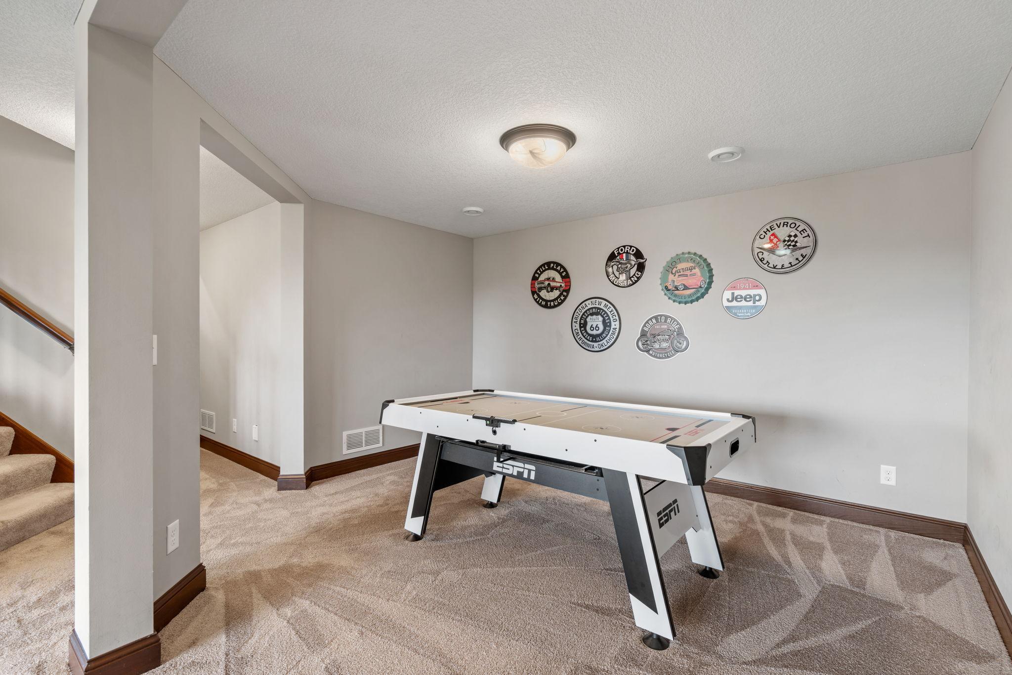 Finished walk-out LL offers another spacious Living Room w/ stone fireplace + built-ins, Gaming Area