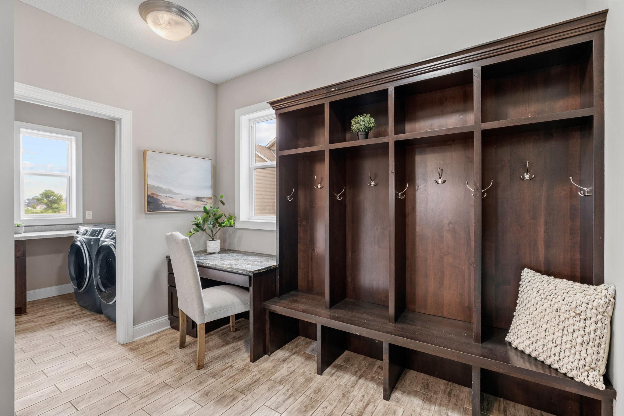 Mudroom w/ custom lockers, desk nook and Laundry Room w/ front-load washer/dryer + sink