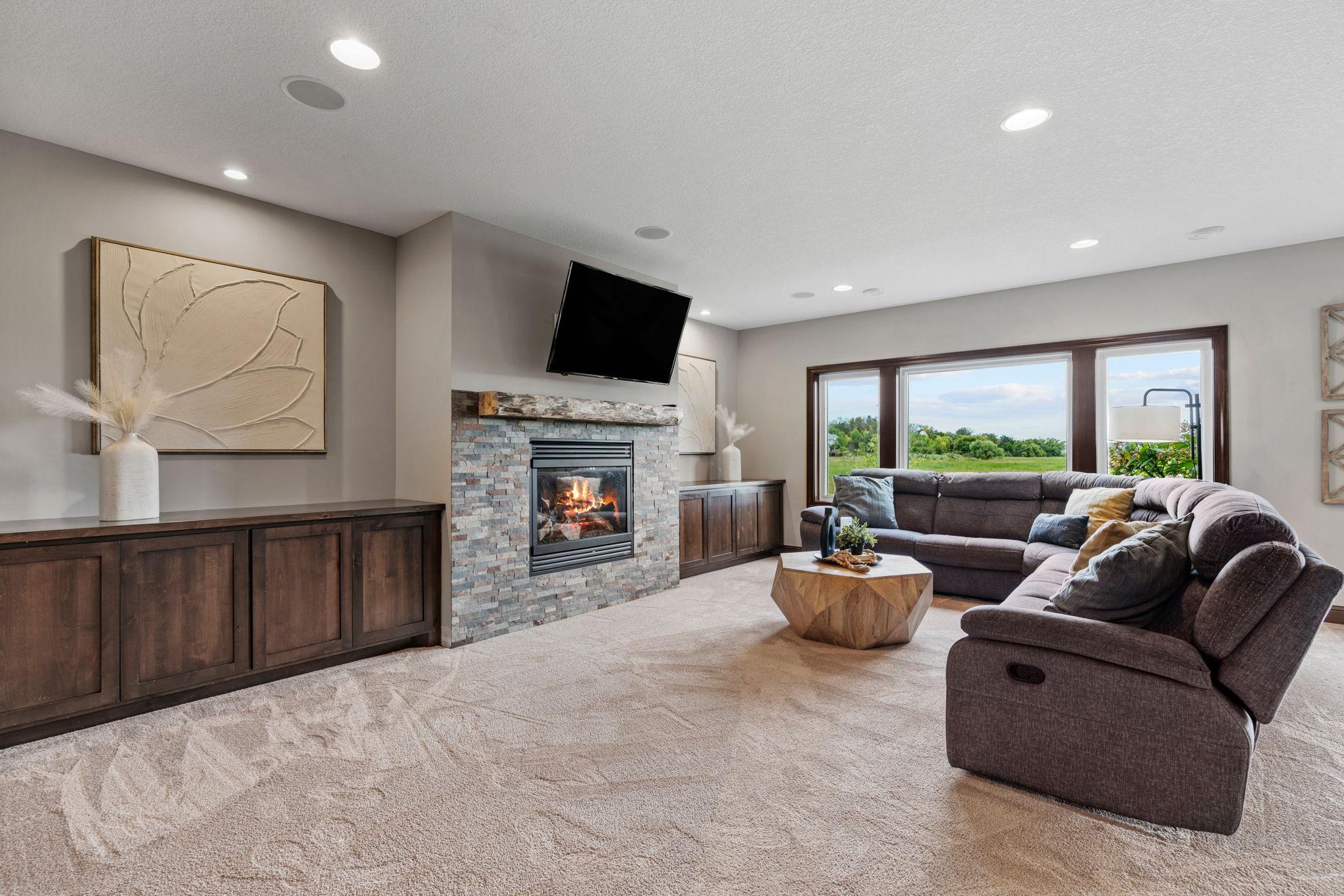 Finished walk-out LL offers another spacious Living Room w/ stone fireplace + built-ins, Gaming Area