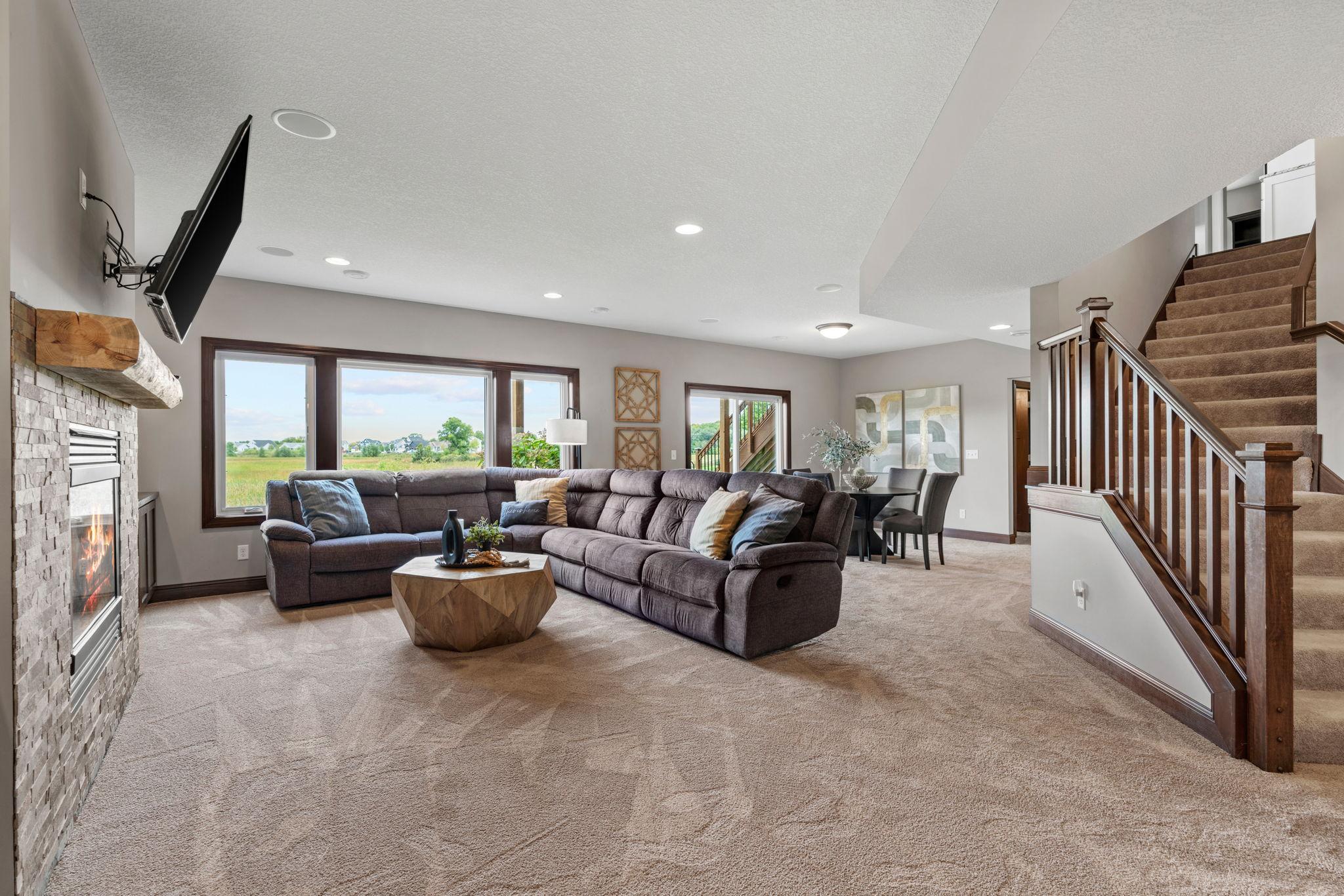 Finished walk-out LL offers another spacious Living Room w/ stone fireplace + built-ins, Gaming Area