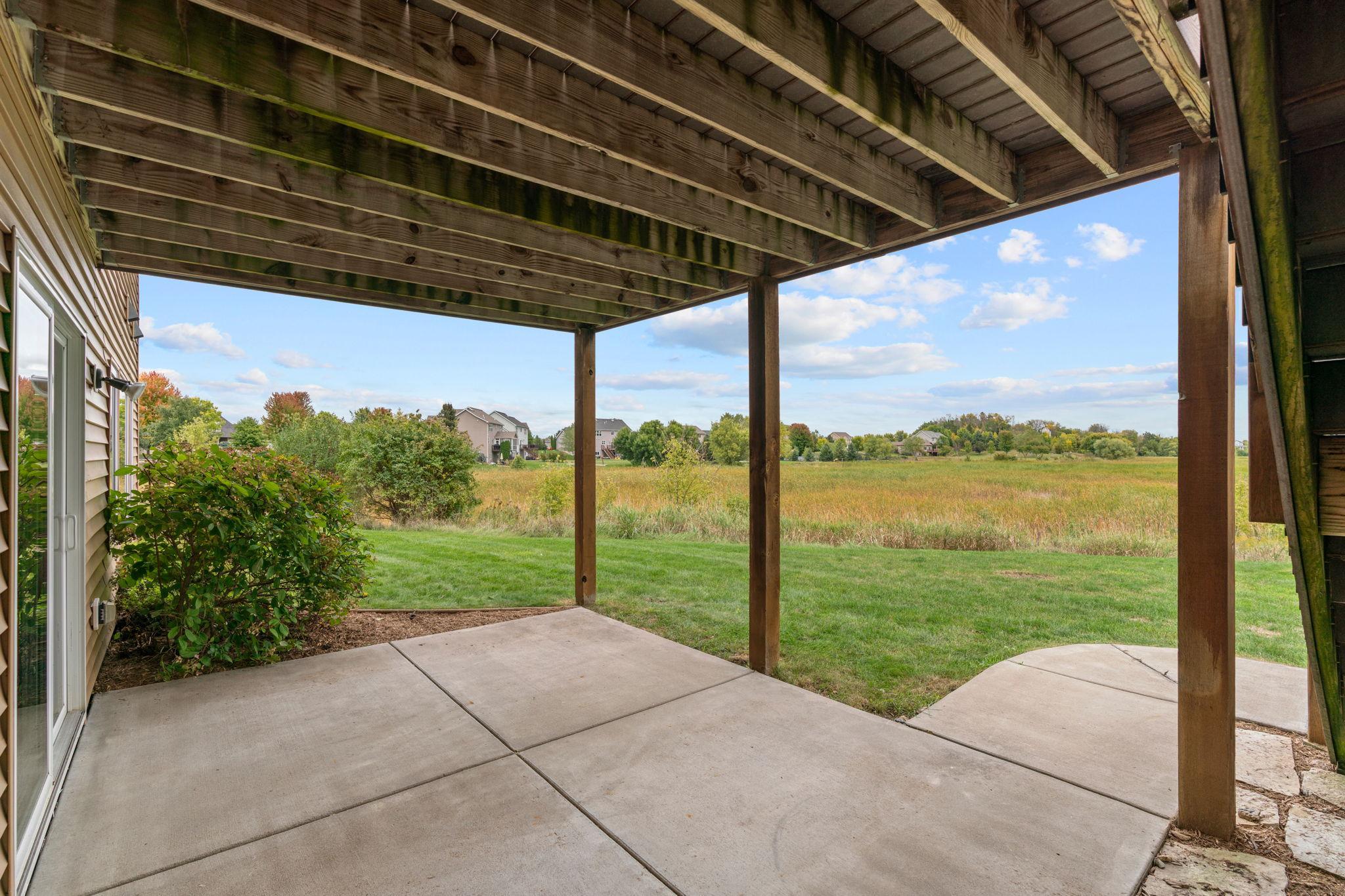 Walk out to the concrete patio + incredible backyard to enjoy campfires around the built-in fire pit