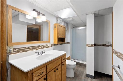 Lower-level bathroom offers convenient access from both the bedroom and common living area.