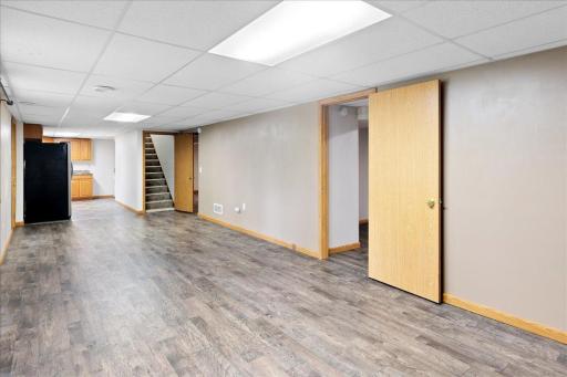 Another view highlights the spacious lower-level living area with convenient access to the kitchen and bedrooms.