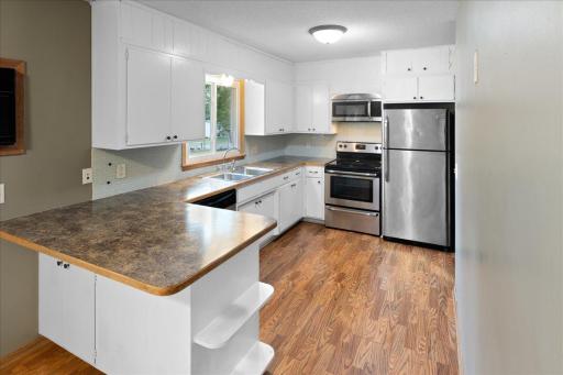 Bright main-level kitchen offers abundant cabinetry, generous counter space, and stainless-steel appliances.