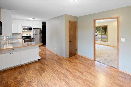 Main-level dining and kitchen spaces flow easily together, with the living room just beyond.