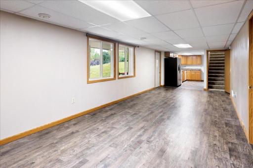 Generous lower-level living room flows directly into the kitchen, creating a comfortable and functional living space.