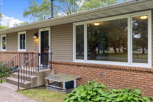 Main-level residence features a private front entrance off Oak Circle and a large picture window bringing abundant natural light inside.