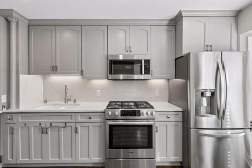 Quartz countertop and backsplash, enameled cabinetry - architectural details and thoughtful layout