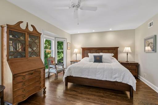 Primary bedroom is expansive. Bay window overlooks the back yard with lush greenery.