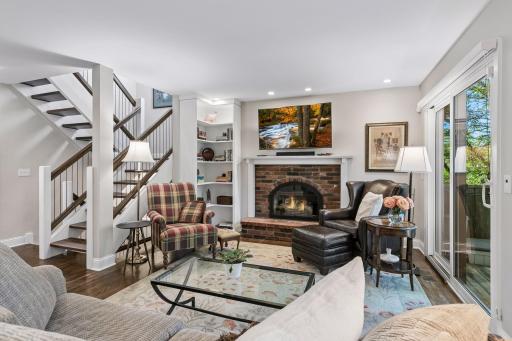 Living room is well appointed with gas fireplace, built in bookcase, and access to the backyard patio