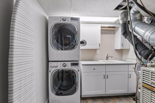 Laundry room with cabinetry for storage and laundry folding