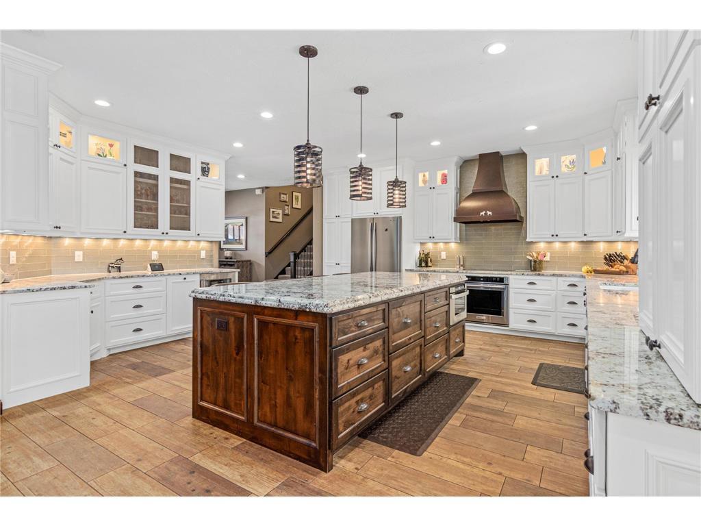 Stunning kitchen with high end finishes, copper hood, large center island and so much light!