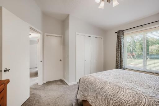 Primary bedroom with direct access to the bath, and window overlooking the backyard.