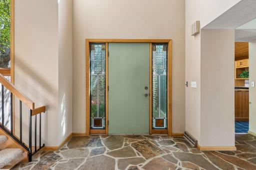 to a front entry with stained glass details