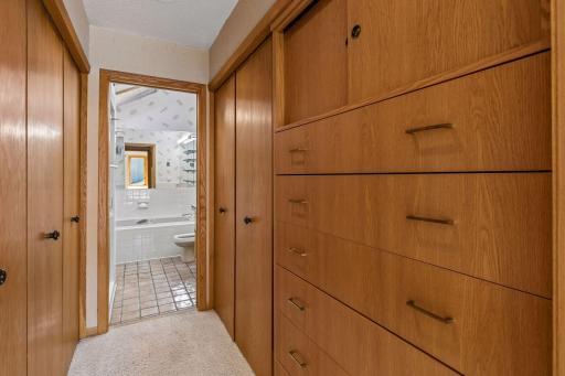 has walk-through custom cabinetry between bedroom and master bath.