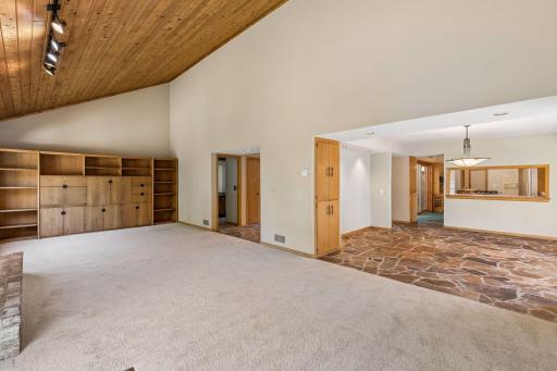 Open floor plan from newly carpeted living room to dining room.