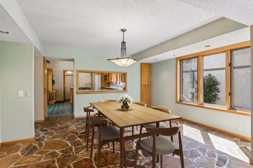 Virtually staged, dining room also has stone floor.