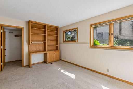 Second lower level bedroom with large walk-in closet and built in bookcases and desk.