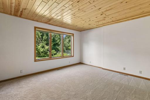 Warm, rich pine paneling in bedroom.