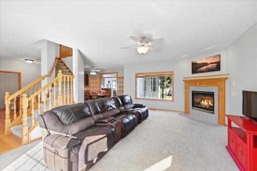 Comfortable living room filled with natural light, open flow and a fireplace.