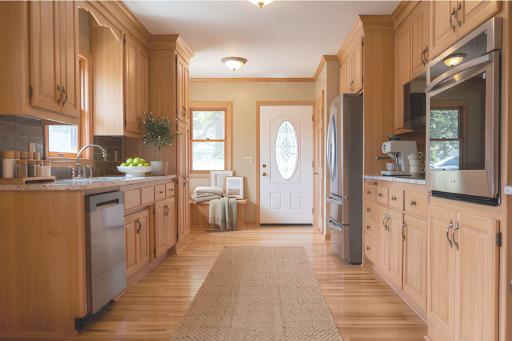 Sunny and bright kitchen with all-new appliances, granite countertops and hardwood floors. Virtually staged.