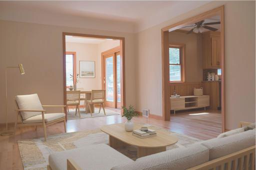 Open concept Living Room flows to the Diningroom/Sunroom with a walk out to the patio. Virtually staged.
