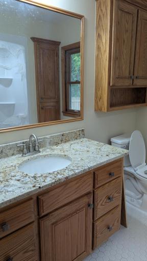 Main level Remodeled Bathroom with granite countertops.