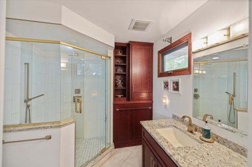 Tastefully appointed ensuite glass enclosed shower and ample storage.