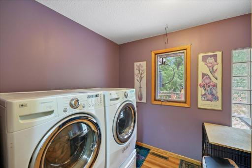 Main floor laundry room with additional storge and folding counter.