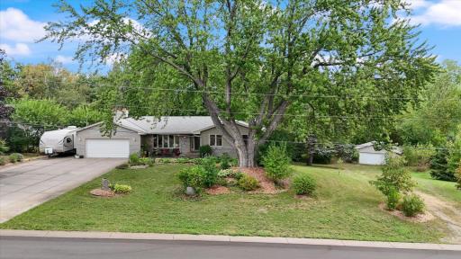 Mature trees, fields, pond and additional detached garage