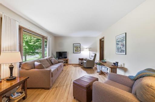 Spacious living room with updated windows and gleaming hardwood floors!