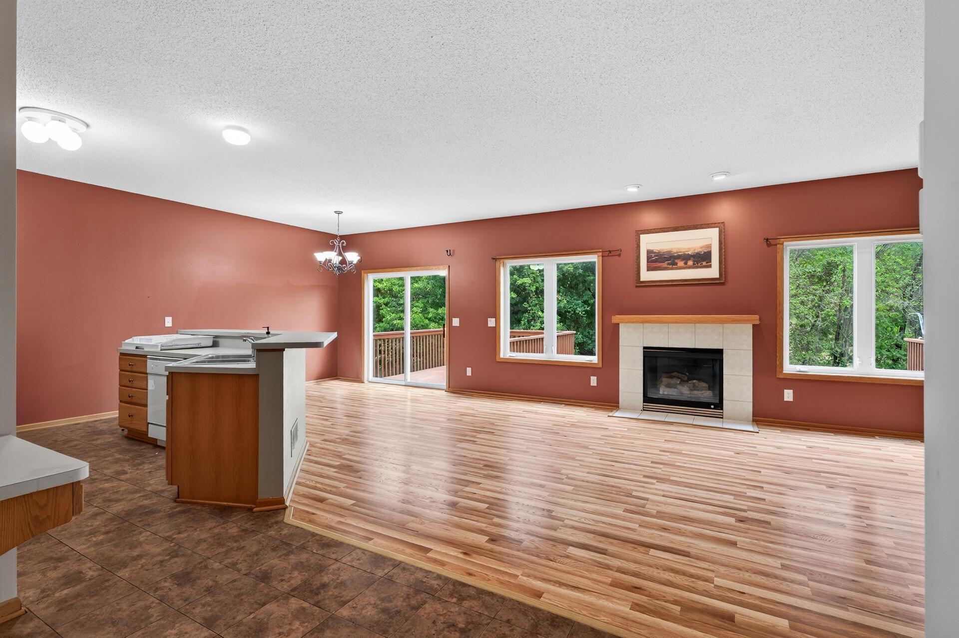 Bright and open main level living area with gas fireplace and look at how private this backyard is!