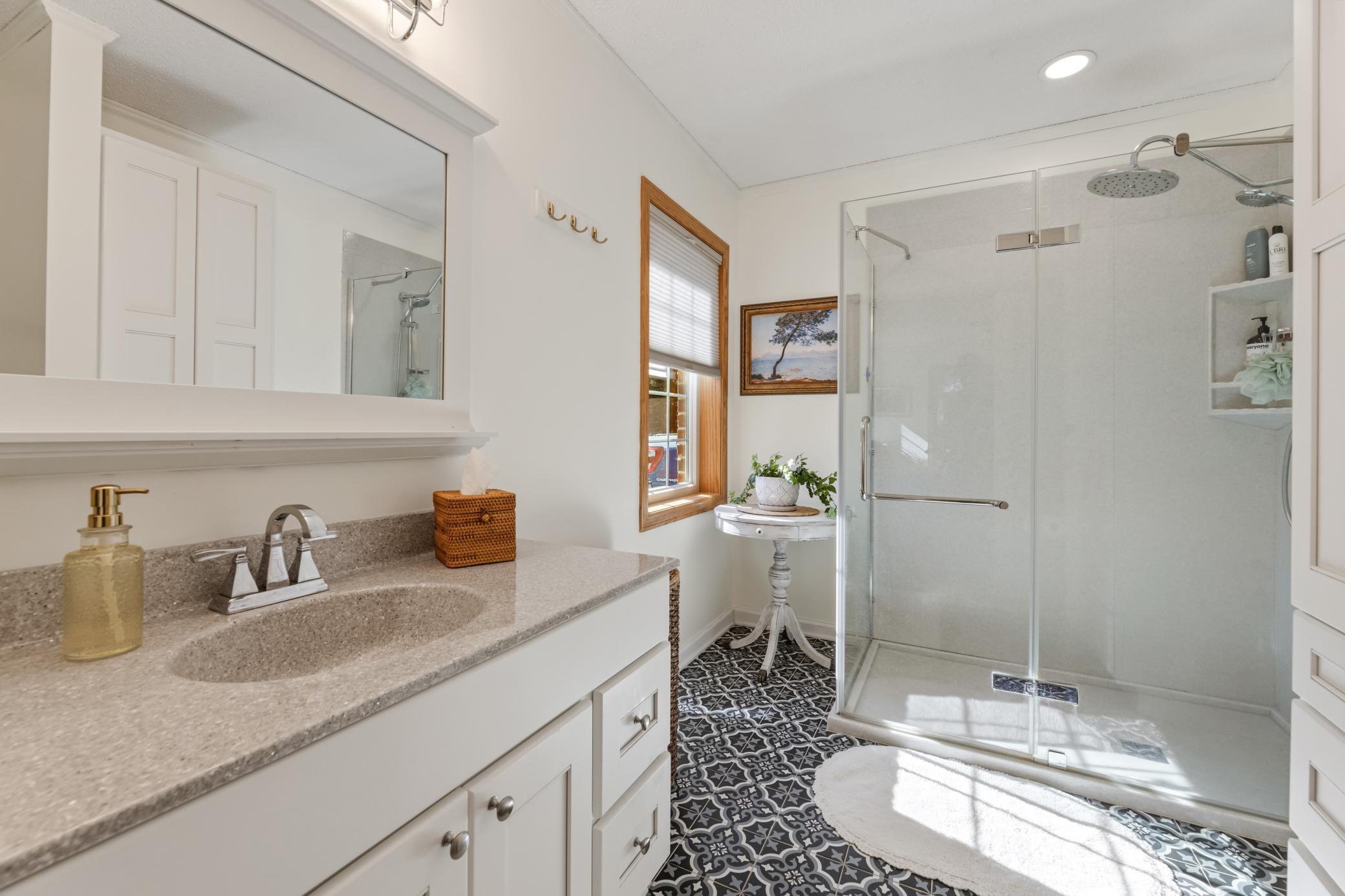 Spacious private primary bath with a large vanity and beautifully updated walk-in shower.