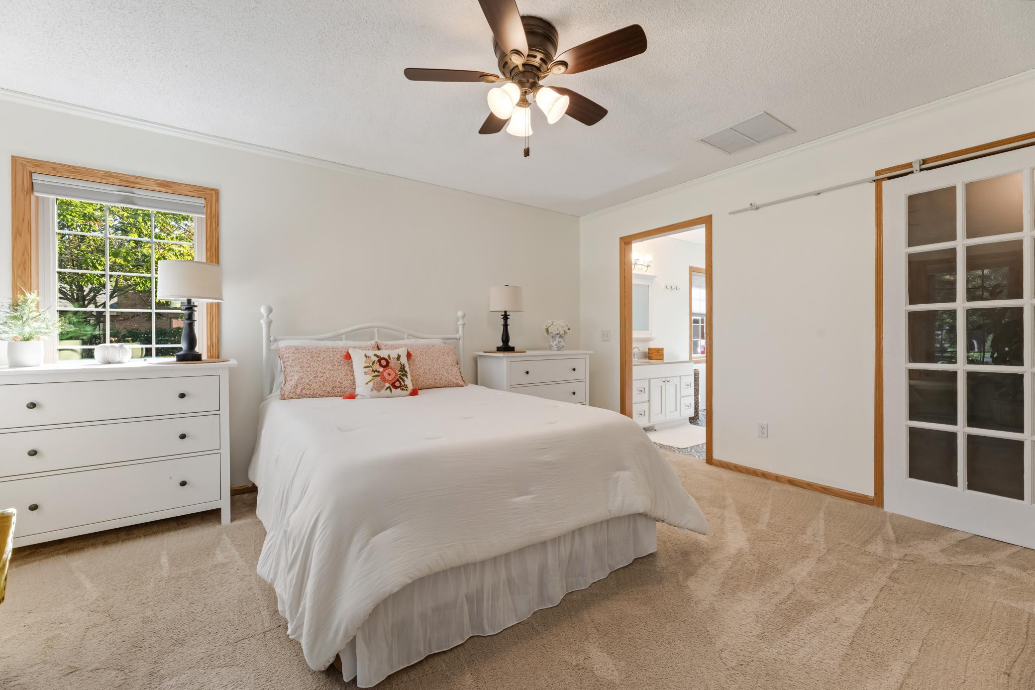 Main-level primary bedroom makes true one-level living possible.