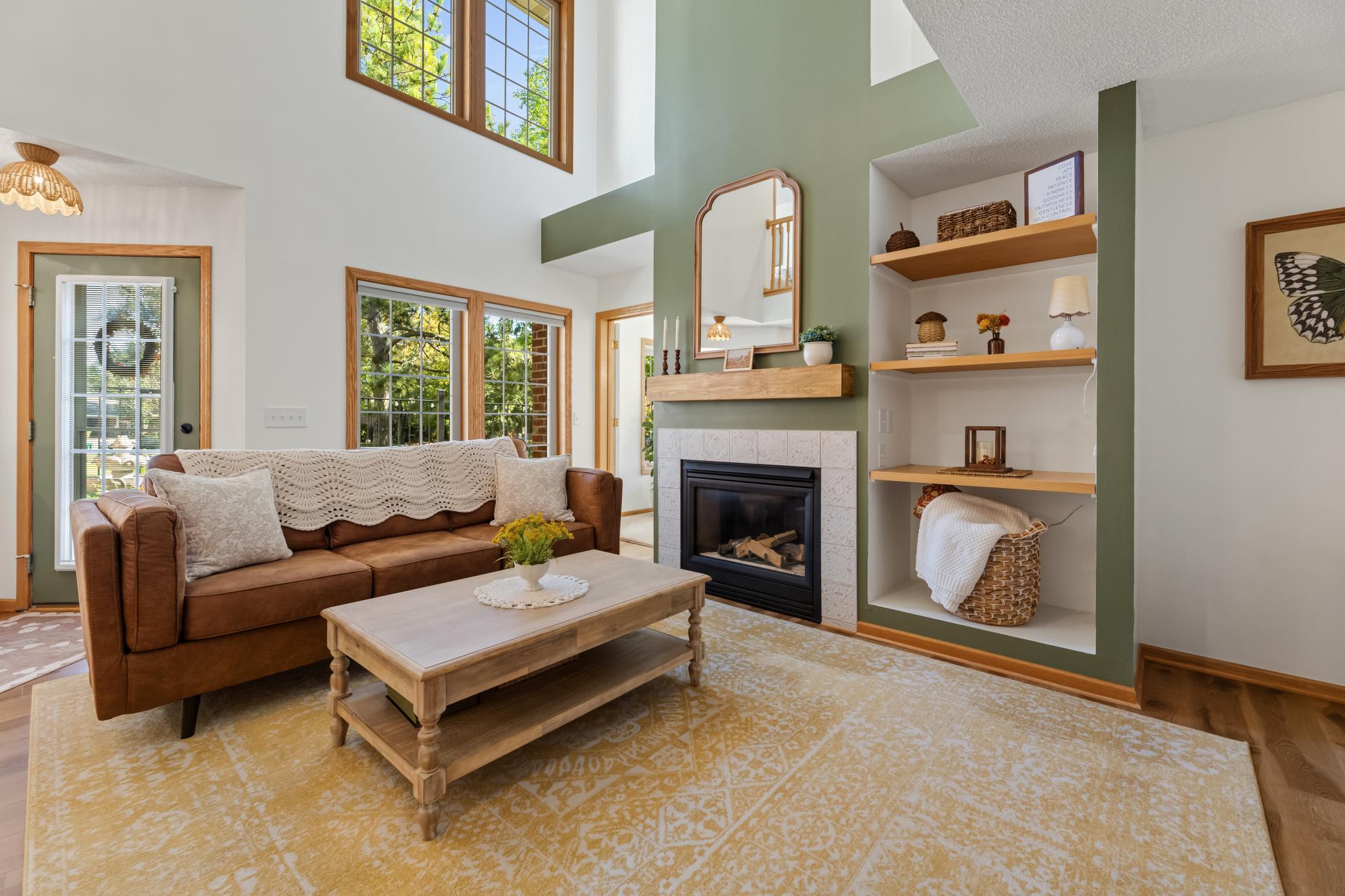 Inside, soaring ceilings, expansive windows and a cozy fireplace make an impressive first impression.