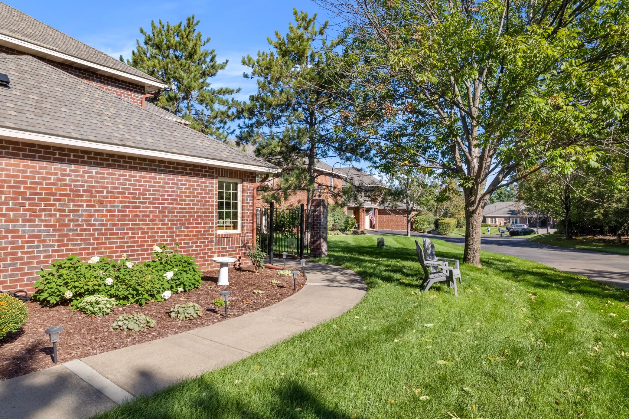 Manicured grounds and mature trees add to the peaceful neighborhood setting.