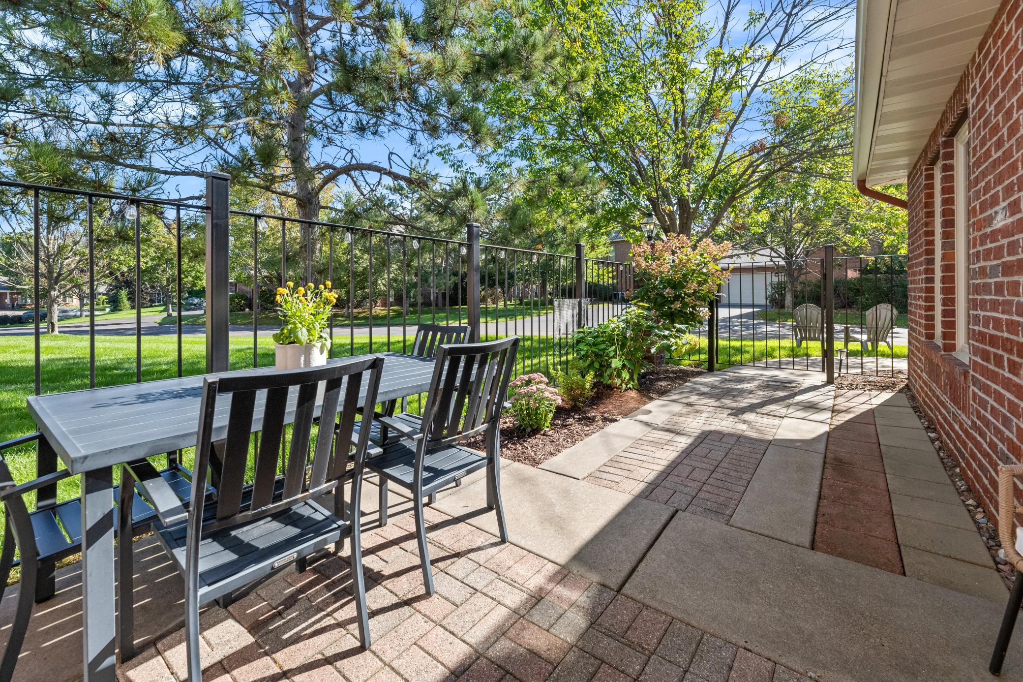 Step outside to a lovely patio surrounded by mature landscaping and greenery.